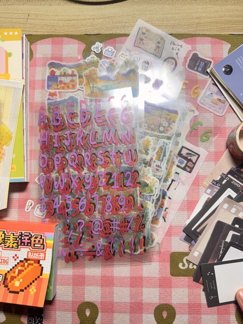 Journaling Materials for take all (Category: Stationery & School Supplies) located in Taytay. Submitted by patchesforless (Listing ID 1466030521, Image 3). Description: - Massive bundle of journaling supplies - Includes colorful material paper pads, Morandi sticker book, and alphabet letter stickers - Features vintage film frame memo sheets, cute pastel character stickers, and patterned paper - Perfect for bullet journals, scrapbooking, and vario