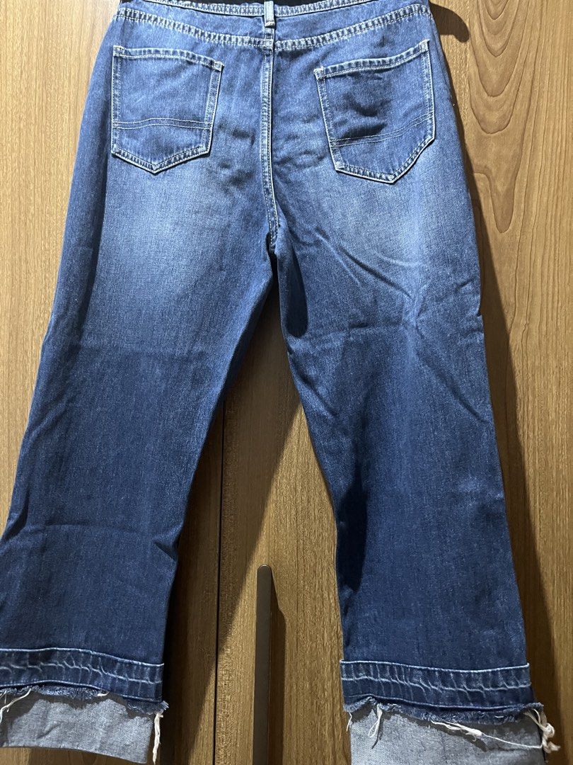 just g. Distressed Blue Denim Jeans Size 36 (Category: Jeans) located in Quezon City. Submitted by epictiger.c6451a (Listing ID 1465967119, Image 3). Description: - Brand: Just G - Wash: Medium blue with light fading - Size: 36 - Rise: Mid-rise with button and zip fly - Details: Distressed accents near front pockets and thighs - Hem: Rolled cuffs with raw frayed edges - Pockets: Classic five-pocket design - Material: Sturdy cotton denim.