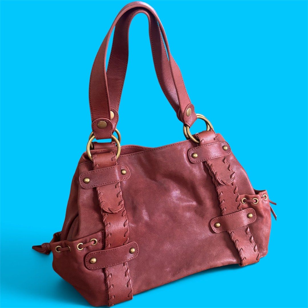 KOOBA Brown Leather Shoulder Bag with Brass Hardware (Category: Shoulder Bags) located in Batangas. Submitted by missraee (Listing ID 1466004334, Image 1). Description: LIKE NEW! Super nice leather material - Color/Material: Rich reddish brown leather with earthy tones - Straps: Double shoulder straps with sturdy round brass rings - Details: Unique laced strap design on front panels with brass rivets and eyelets - Interior: Roomy main compartment