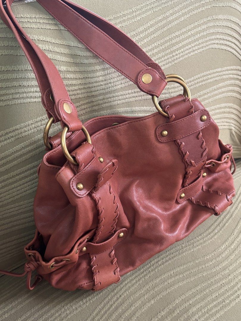 KOOBA Brown Leather Shoulder Bag with Brass Hardware (Category: Shoulder Bags) located in Batangas. Submitted by missraee (Listing ID 1466004334, Image 3). Description: LIKE NEW! Super nice leather material - Color/Material: Rich reddish brown leather with earthy tones - Straps: Double shoulder straps with sturdy round brass rings - Details: Unique laced strap design on front panels with brass rivets and eyelets - Interior: Roomy main compartment