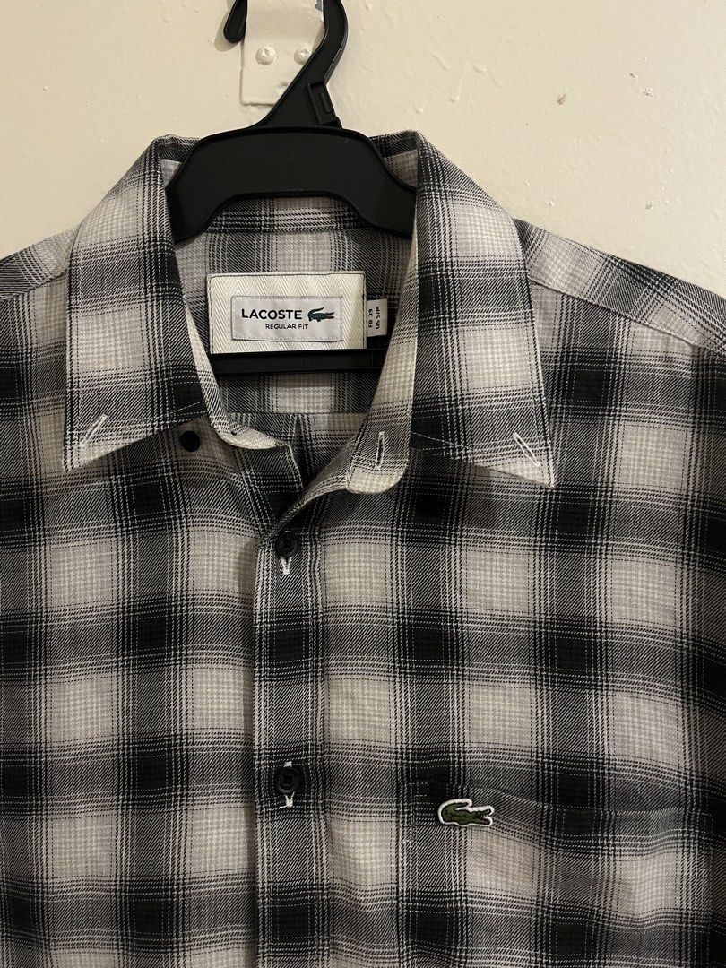 Lacoste Black White Plaid Regular Fit Button Down Shirt (Category: Tshirts & Polo Shirts ) located in Paranaque City. Submitted by alasthrift26 (Listing ID 1465966950, Image 2). Description: - Brand: Lacoste - Style: Long sleeve button-down shirt - Pattern: Classic black and white plaid - Size: Tagged FR 39 (Fits US S/M) - Measurements: 21 inches pit to pit, 29.5 inches length - Details: Regular fit, front chest pocket, signature embroidered gree