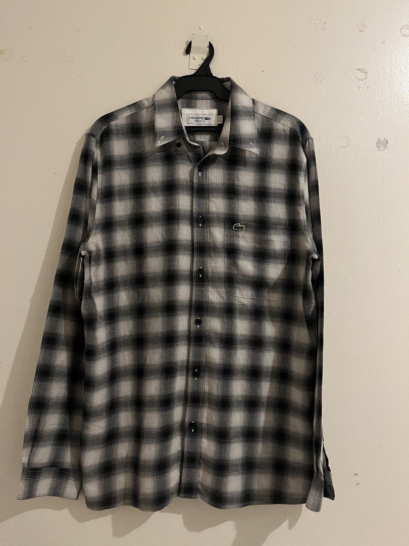 Lacoste Black White Plaid Regular Fit Button Down Shirt (Category: Tshirts & Polo Shirts ) located in Paranaque City. Submitted by alasthrift26 (Listing ID 1465966950, Image 1). Description: - Brand: Lacoste - Style: Long sleeve button-down shirt - Pattern: Classic black and white plaid - Size: Tagged FR 39 (Fits US S/M) - Measurements: 21 inches pit to pit, 29.5 inches length - Details: Regular fit, front chest pocket, signature embroidered gree