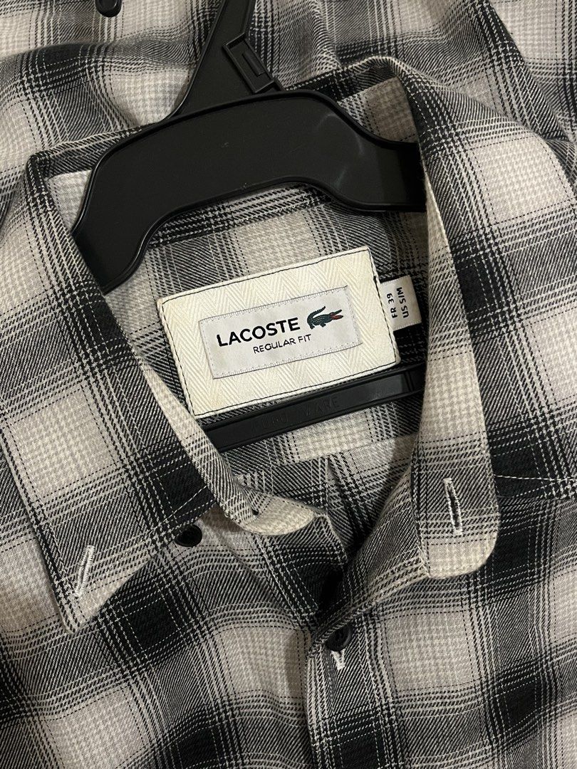 Lacoste Black White Plaid Regular Fit Button Down Shirt (Category: Tshirts & Polo Shirts ) located in Paranaque City. Submitted by alasthrift26 (Listing ID 1465966950, Image 3). Description: - Brand: Lacoste - Style: Long sleeve button-down shirt - Pattern: Classic black and white plaid - Size: Tagged FR 39 (Fits US S/M) - Measurements: 21 inches pit to pit, 29.5 inches length - Details: Regular fit, front chest pocket, signature embroidered gree