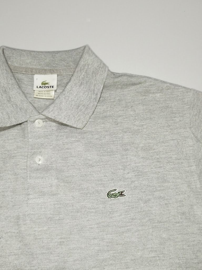 Lacoste Grey Polo Shirt (Category: Tshirts & Polo Shirts ) located in Caloocan City. Submitted by silverdragon_aaed38 (Listing ID 1466108252, Image 2). Description: -Lacoste Classic Grey - Complete tags - Size 7 / XL - Dimes W23/23.5 L29/30 - Color Rate 10 - No issue - Style: Short sleeves, classic collar, two pearl buttons - Detail: Small black embroidered crocodile logo on the left chest - Fit: Ribbed cuffs and hem for a comfortable fit - Condi