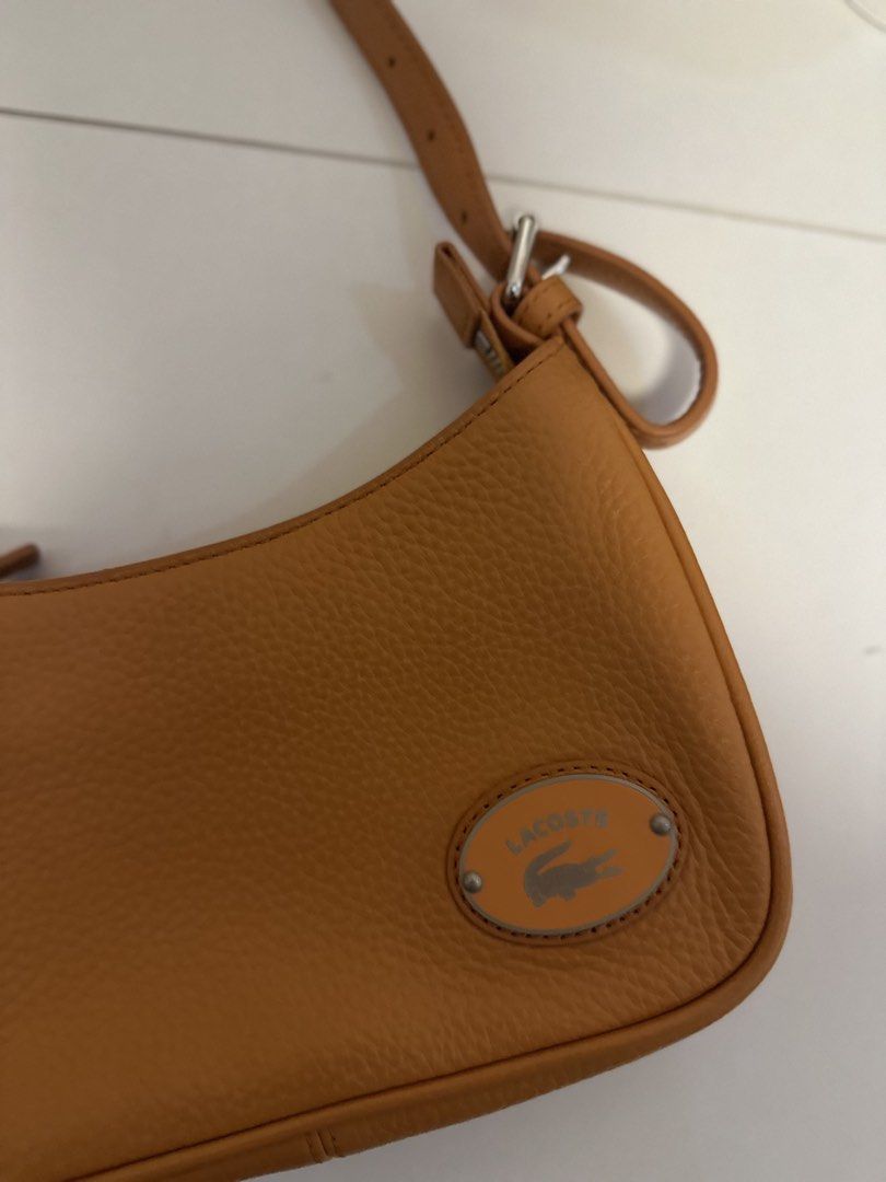 Lacoste Handbag (Category: Shoulder Bags) located in Manila. Submitted by mg2829 (Listing ID 1466045354, Image 3). Description: Women’s Lacoste Metal Plate Grained Leather Shoulder Bag in Orange. Bought in Citygate Outlet in Hongkong.