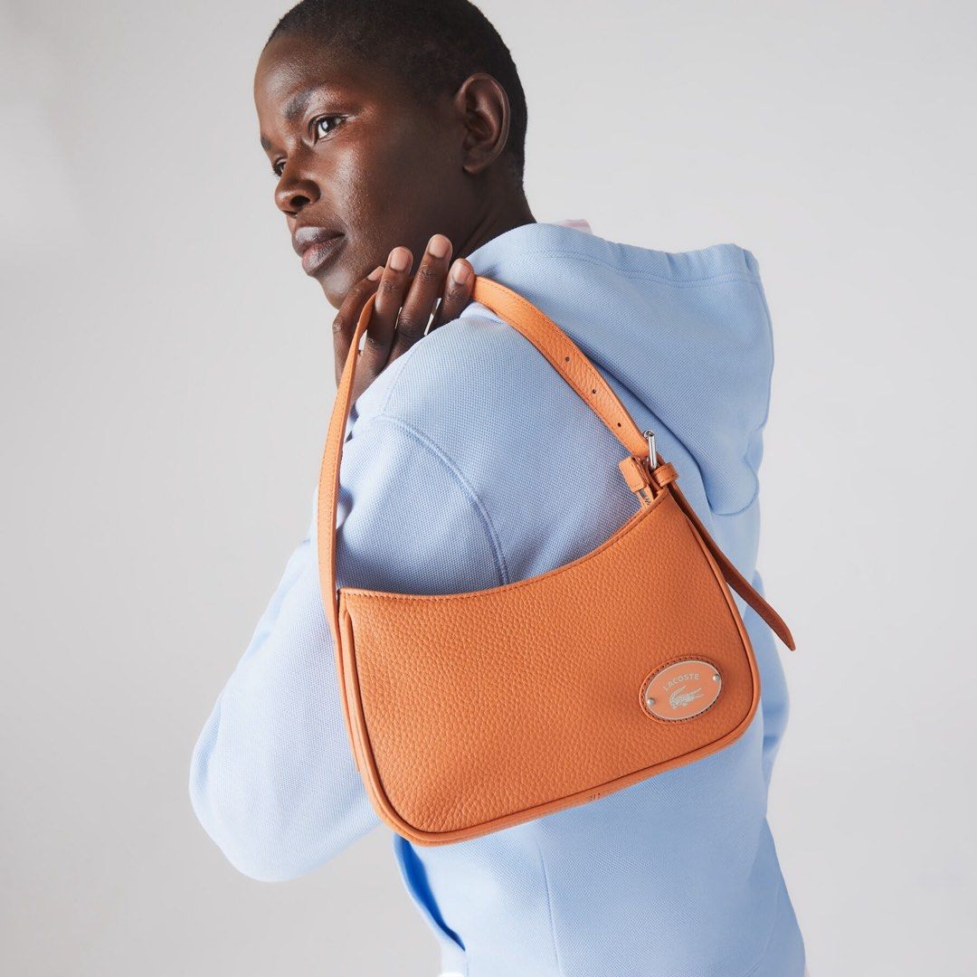 Lacoste Handbag (Category: Shoulder Bags) located in Manila. Submitted by mg2829 (Listing ID 1466045354, Image 1). Description: Women’s Lacoste Metal Plate Grained Leather Shoulder Bag in Orange. Bought in Citygate Outlet in Hongkong.