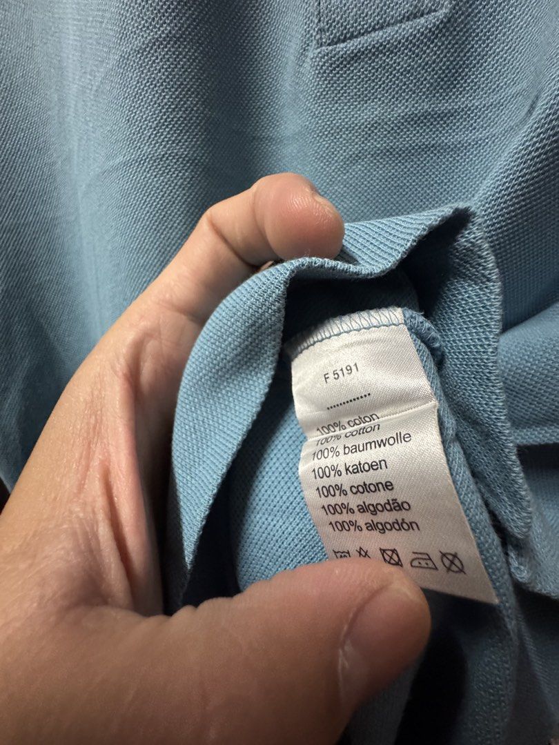 Lacoste Light Blue Polo Shirt Size 4 / M (Category: Tshirts & Polo Shirts ) located in Tangub. Submitted by laurbepena33002 (Listing ID 1465955455, Image 3). Description: - Brand: Lacoste - Color: Light Blue - Size: 4 (Fits AU Medium) -Dimension: W22”xL25.5” - Material: Classic cotton petit pique knit - Features: Traditional two-button placket with dark buttons and signature embroidered green crocodile logo - Condition: Clean interior neck tags a