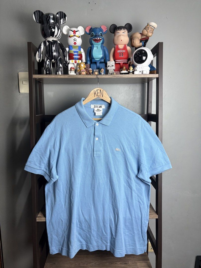 Lacoste Light Blue Regular Fit Polo Shirt Size 7 (Category: Tshirts & Polo Shirts ) located in Manila. Submitted by thriftnikenv.2 (Listing ID 1465991015, Image 1). Description: - Brand: Lacoste - Color: Light Blue - Fit: Regular Fit - Size: Tag 7 - Material: 100% Cotton (Made in Peru) - Details: Two-button placket with white buttons, iconic embroidered green crocodile logo, ribbed short sleeve cuffs - Condition: Clean collar and solid stitching 