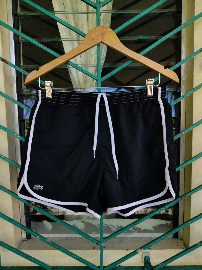 Lacoste Live Black Shorts Size 3 (Category: Shorts) located in Manila. Submitted by geraldquinto_917 (Listing ID 1465964588, Image 1). Description: - Brand: Lacoste Live - Color: Black with white piping - Size: 3 -Waist 28-34 - Features: Elastic waistband with branded white drawstring - Pockets: Includes a back pocket - Details: Classic embroidered crocodile logo near the hem - Condition: Excellent, ready to wear.