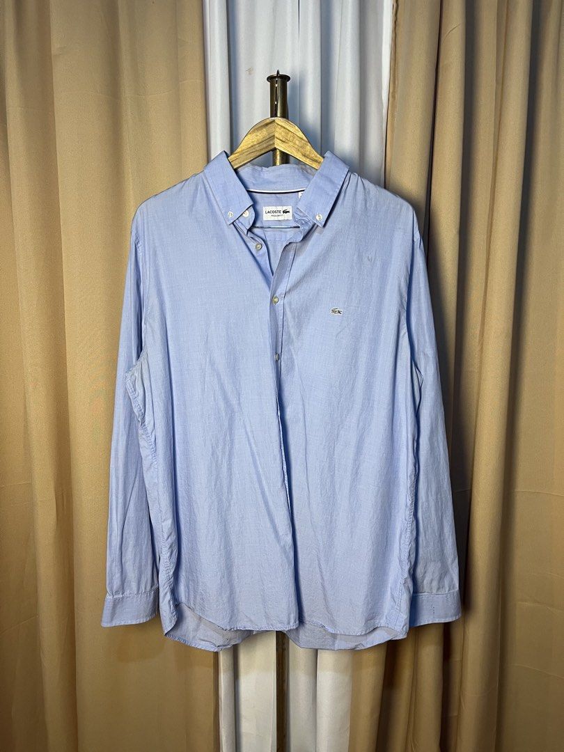 Lacoste Regular Fit Light Blue Long Sleeve Button-Down Shirt (Category: Formal Shirts) located in Kidapawan. Submitted by azythrift (Listing ID 1466049752, Image 1). Description: - Brand: Lacoste - Color: Light blue - Size: US 17 1/2 / FR 44 (Regular Fit) - Details: Button-down collar, front placket, buttoned cuffs - Logo: Iconic embroidered green crocodile on left chest - Condition: Clean, classic, and ready to wear - Style: Great for office wea