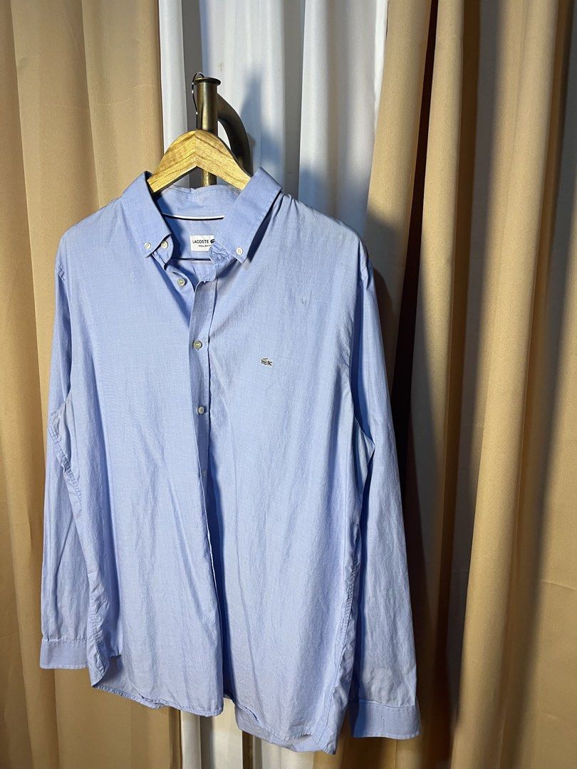 Lacoste Regular Fit Light Blue Long Sleeve Button-Down Shirt (Category: Formal Shirts) located in Kidapawan. Submitted by azythrift (Listing ID 1466049752, Image 2). Description: - Brand: Lacoste - Color: Light blue - Size: US 17 1/2 / FR 44 (Regular Fit) - Details: Button-down collar, front placket, buttoned cuffs - Logo: Iconic embroidered green crocodile on left chest - Condition: Clean, classic, and ready to wear - Style: Great for office wea