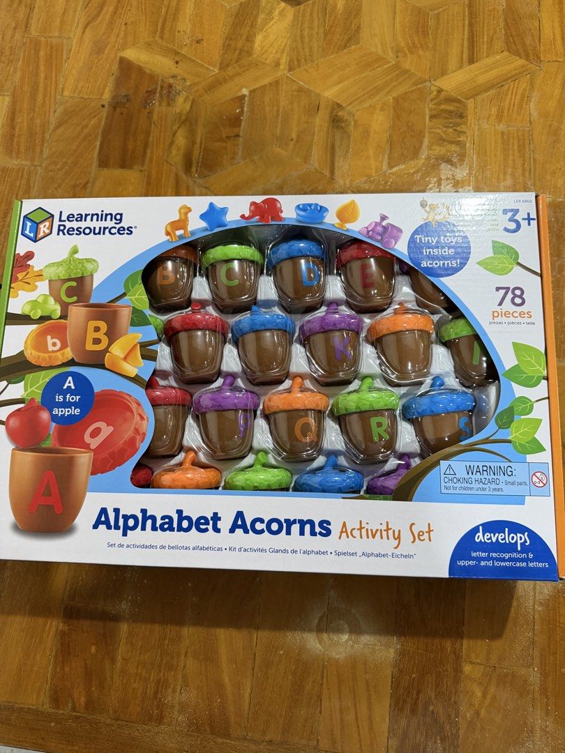 Learning Resources Alphabet Acorns Activity Set (Category: Educational & Learning Toys) located in Manila. Submitted by preloved_new_forsale (Listing ID 1466027071, Image 1). Description: Educational toy for kids ages 3 and up. Helps with letter recognition, upper and lowercase matching, and early word building. 78-piece set includes 26 two-piece acorns and 26 color-coded surprise figures hiding inside. Great hands-on learning activity..