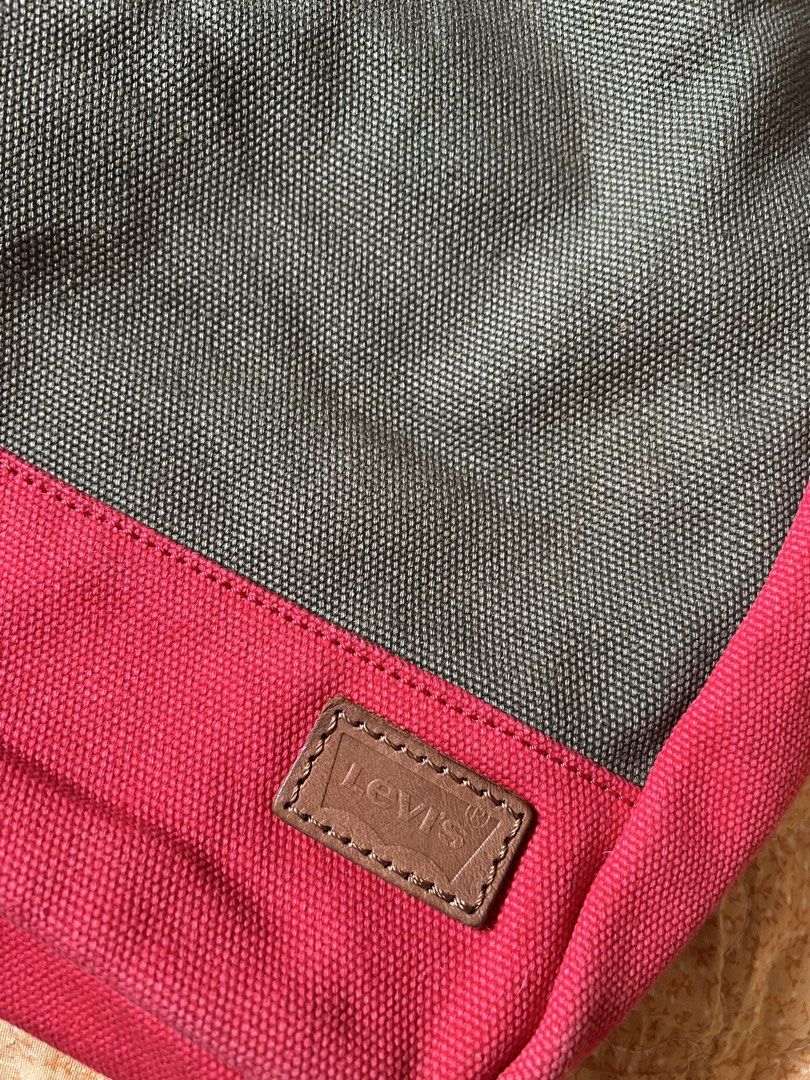 Levi's Canvas and Leather Tote Bag (Category: Tote Bags) located in Cagayan de Oro. Submitted by nelsondel21723 (Listing ID 1466028086, Image 2). Description: - Brand: Levi's - Colorway: Dark green and pink - Material: Sturdy cotton canvas with genuine leather handles - Features: Base patch branding and secure interior zip pocket with logo label - Condition: Great everyday carryall with plenty of room for daily essentials - dimension width 17 X 1
