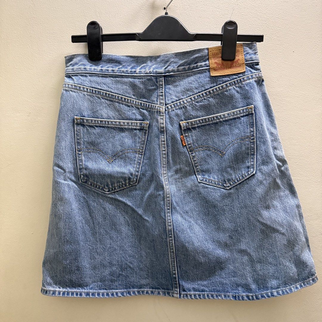 Levi's denim skirt size 26 (Category: Skirts) located in Muntinlupa City. Submitted by lovedbyapril (Listing ID 1466044108, Image 2). Description: - Brand: Levi's - Style: Light blue wash denim A-line skirt - Size: 26 - Closure: Front full zip with round ring pull - Pockets: Front slant pockets and back patch pockets - Details: Iconic Levi's orange tab and leather patch at the waistband - Condition: Brand new, no tag 💌 RFS: Decluttering, need st
