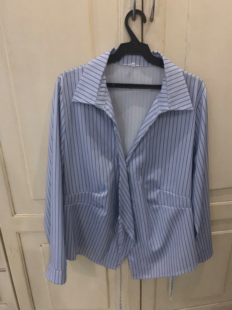 Light blue striped long sleeve button down shirt top (Category: Longsleeves) located in Manila. Submitted by pureforest_68db5f (Listing ID 1466075455, Image 1). Description: - Color & Pattern: Light blue with dark vertical pinstripes - Design: Classic lapel collar, button-front, and faux waist pockets - Unique Feature: Stylish twisted hem design with hanging ties - Fabric: Lightweight and comfortable - Versatility: Perfect for office wear or casu