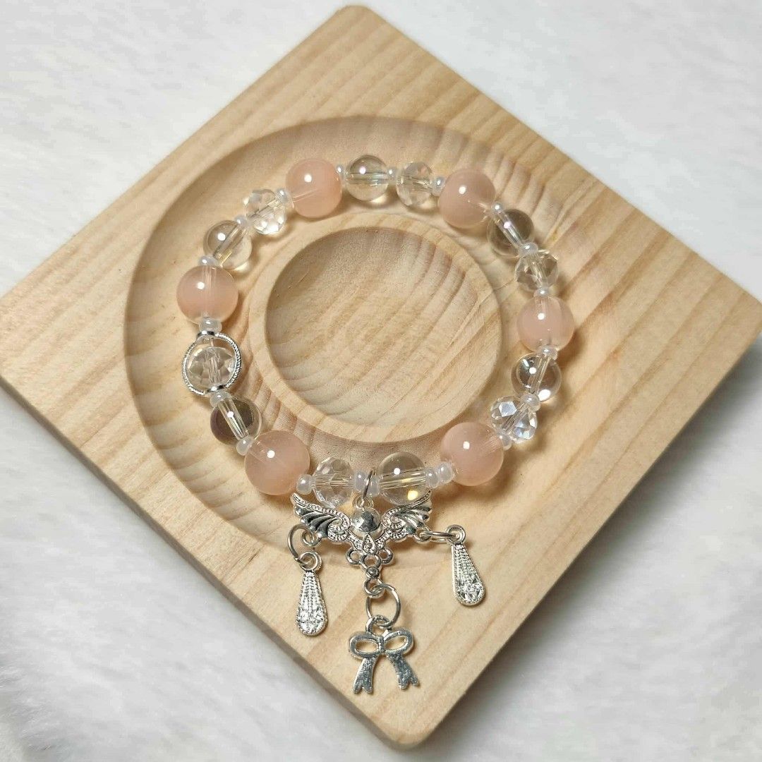 Light orange Beaded Bracelet with Silver Charms (Category: Bracelets) located in Taguig. Submitted by fits.for.less (Listing ID 1466094813, Image 1). Description: 60 pesos MOP: Gcash MOD: lalamove/grab, pick-up if malapit lang.