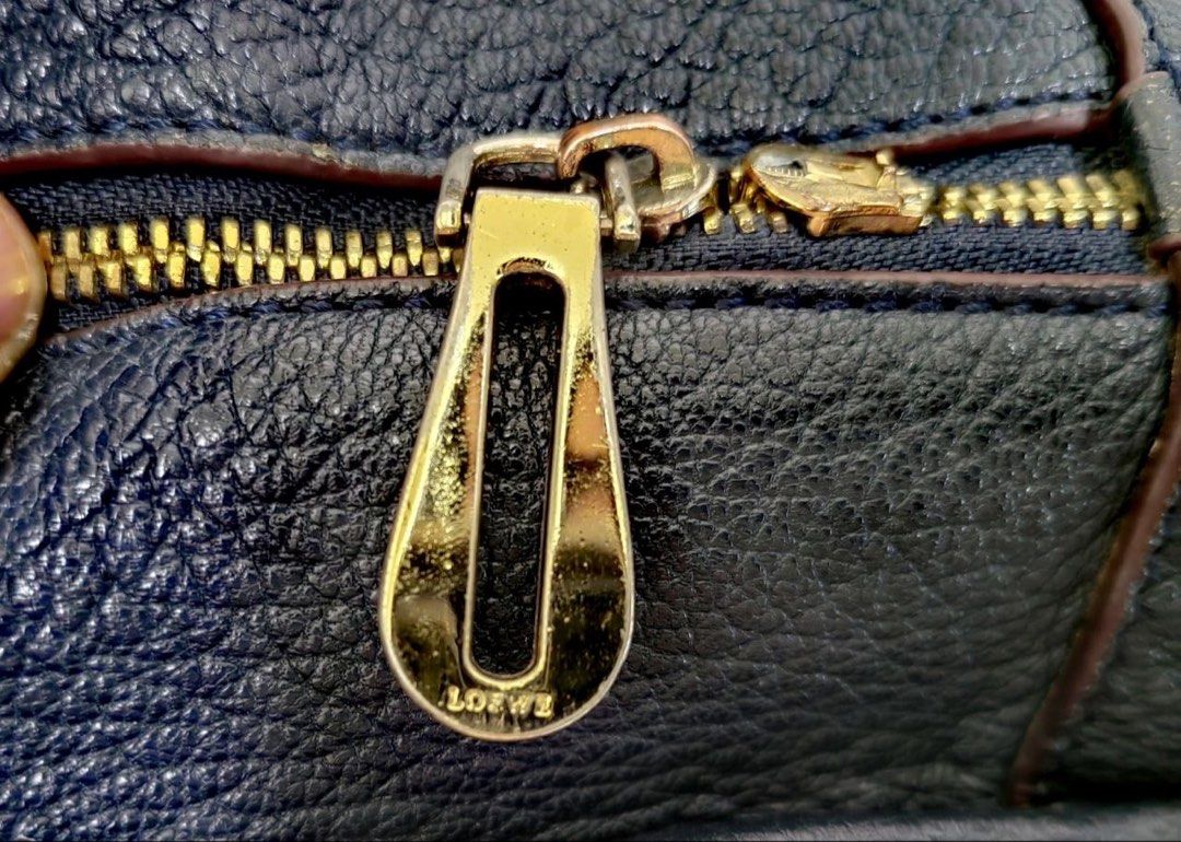 Loewe Blue Leather Amazona bag (Category: Luxury Bags & Wallets) located in Manila. Submitted by junejanuary (Listing ID 1466145374, Image 2). Description: - Loewe blue leather handbag - Striking embossed logo in the center - Elegant gold hardware on handles and strap attachments - Structured shape with chic dark red edge glazing - Double top handles with rectangular loops - Includes matching adjustable leather strap with buckles and clips - Cond