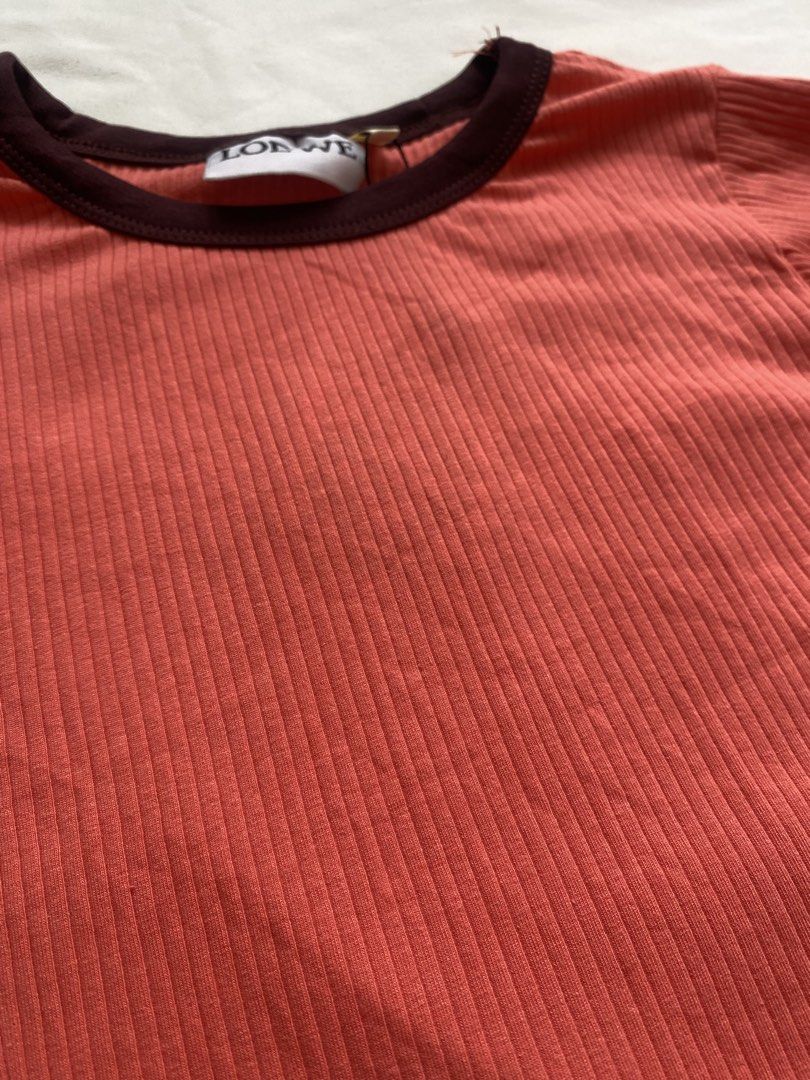 LOEWE Ribbed Ringer Crop Top (Category: Sleeveless) located in Manila. Submitted by vestige_collection (Listing ID 1466104289, Image 2). Description: -LOEWE ribbed crop top in coral pink. -Dark brown contrast piping on the crew neck and short sleeves. -Fitted silhouette. -Branded neck label attached. -Stretchy ribbed cotton fabric. - Simple everyday staple piece. -Easy to match with high-waisted denim or skirts. -XS.