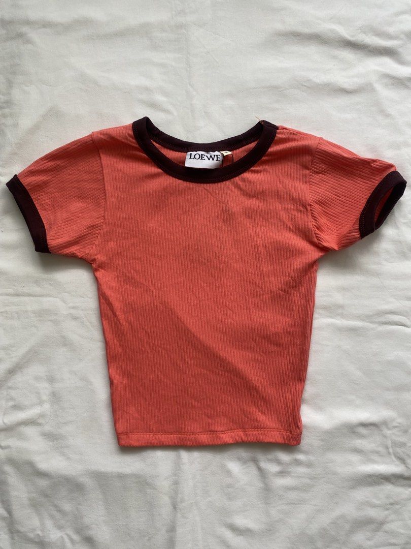 LOEWE Ribbed Ringer Crop Top (Category: Sleeveless) located in Manila. Submitted by vestige_collection (Listing ID 1466104289, Image 1). Description: -LOEWE ribbed crop top in coral pink. -Dark brown contrast piping on the crew neck and short sleeves. -Fitted silhouette. -Branded neck label attached. -Stretchy ribbed cotton fabric. - Simple everyday staple piece. -Easy to match with high-waisted denim or skirts. -XS.