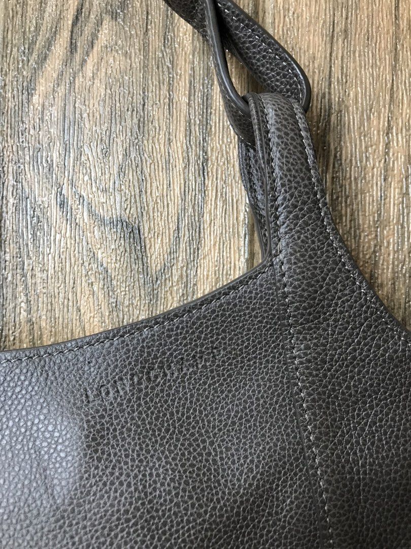 Longchamp Grey Leather Hobo Shoulder Bag (Category: Luxury Bags & Wallets) located in Aloguinsan. Submitted by jayhooukay (Listing ID 1466077287, Image 2). Description: - 67,000 brand new , sa akin 8,500 - Authentic Longchamp grey pebbled leather shoulder bag - Soft, slouchy hobo design with a sturdy structured base - Elegant gold-tone hardware with engraved branding - Clean branded nylon interior featuring multiple pockets and a secure zipped co