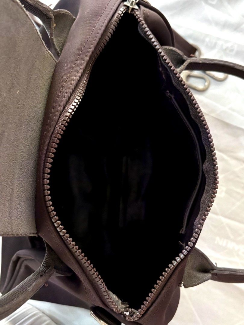 Longchamp Le Pliage Cuir Top Handle Bag Brown (Category: Luxury Bags & Wallets) located in Solano. Submitted by annbusinessell (Listing ID 1466120351, Image 2). Description: - Brand: Longchamp - Color: Dark Brown - Material: Durable nylon and leather trim with silver hardware - Closure: Top zip with signature leather snap flap - Straps: Dual top handles and adjustable fabric shoulder strap - Interior: Clean lining with convenient open pockets - C