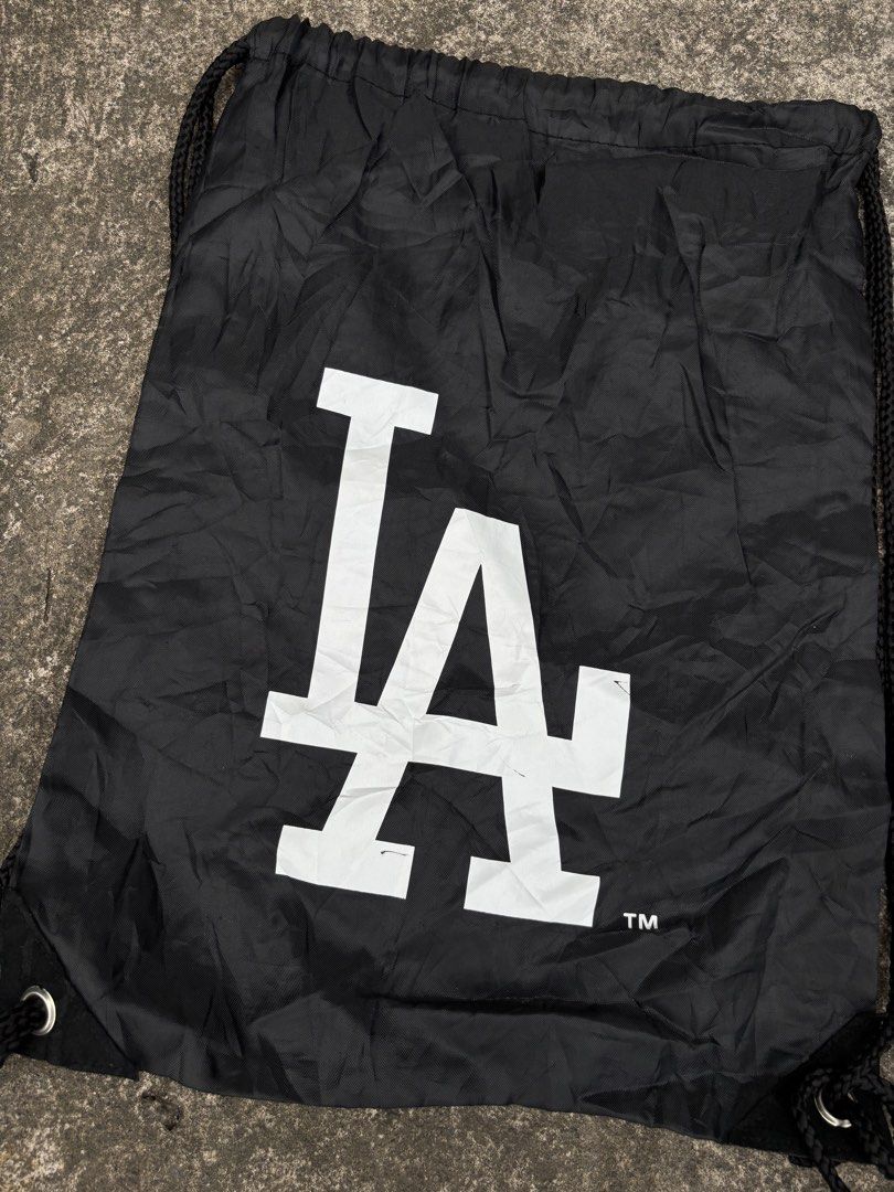 Los Angeles Dodgers MLB Black Drawstring Bag (Category: Backpacks) located in Naga. Submitted by ajrc.shop (Listing ID 1466093574, Image 3). Description: MLB Los Angeles Dodgers drawstring bag ✅Size: S ✅Width: 12.5 ✅Length: 17.2 ✅Color Rate: 9/10 ✅Issue: Nasa pic ✅Need Wash ✅Location: Bicol Naga City, Camarines Sur ✅Courier: J&T Express/Flash Express ✅MOP: Gcash only.