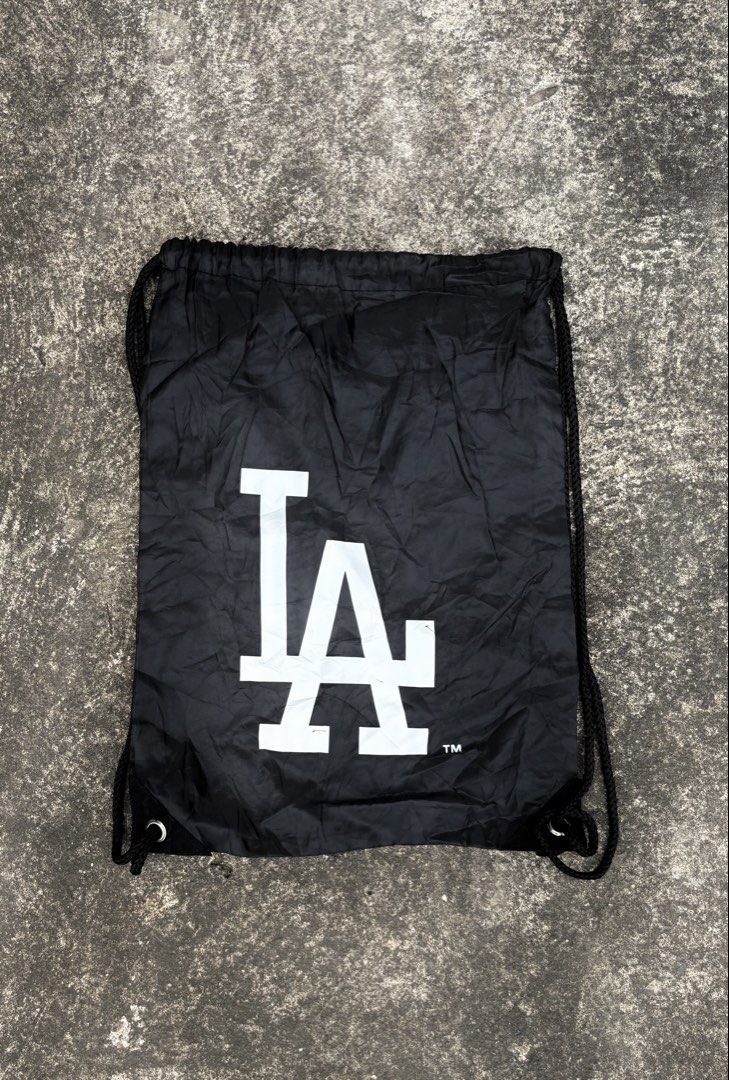 Los Angeles Dodgers MLB Black Drawstring Bag (Category: Backpacks) located in Naga. Submitted by ajrc.shop (Listing ID 1466093574, Image 1). Description: MLB Los Angeles Dodgers drawstring bag ✅Size: S ✅Width: 12.5 ✅Length: 17.2 ✅Color Rate: 9/10 ✅Issue: Nasa pic ✅Need Wash ✅Location: Bicol Naga City, Camarines Sur ✅Courier: J&T Express/Flash Express ✅MOP: Gcash only.