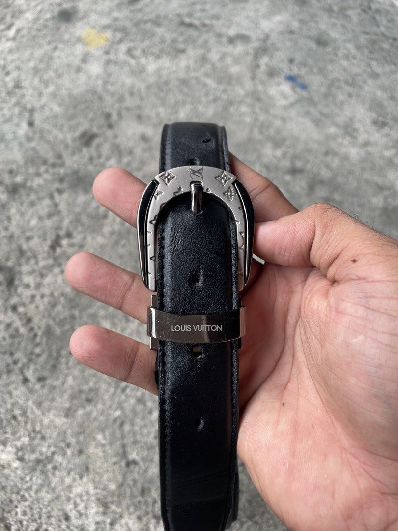 Louis Vuitton Black Leather Belt with Silver Buckle (Category: Belts) located in Polangui. Submitted by b0ssl00ts (Listing ID 1465962199, Image 1). Description: - Brand: Louis Vuitton - Material: Sturdy black leather with visible grain texture - Hardware: Silver metal buckle with engraved monogram flowers and LV initials - Details: Matching silver keeper loop with stamped Louis Vuitton lettering - Fit: Classic adjustable prong closure with multip