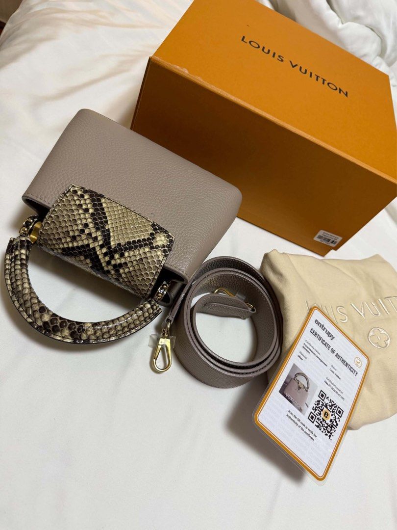 Louis Vuitton Capucines Mini Python Handle Bag (Category: Luxury Bags & Wallets) located in Cainta. Submitted by jtc23 (Listing ID 1466147387, Image 2). Description: - Model: Louis Vuitton Capucines Mini - Material: Greyish taupe taurillon leather with exotic python skin handle and flap closure - Hardware: Elegant gold-tone - Strap: Removable matching shoulder strap for versatile styling - Condition: Pristine condition, carefully stored (shape ma