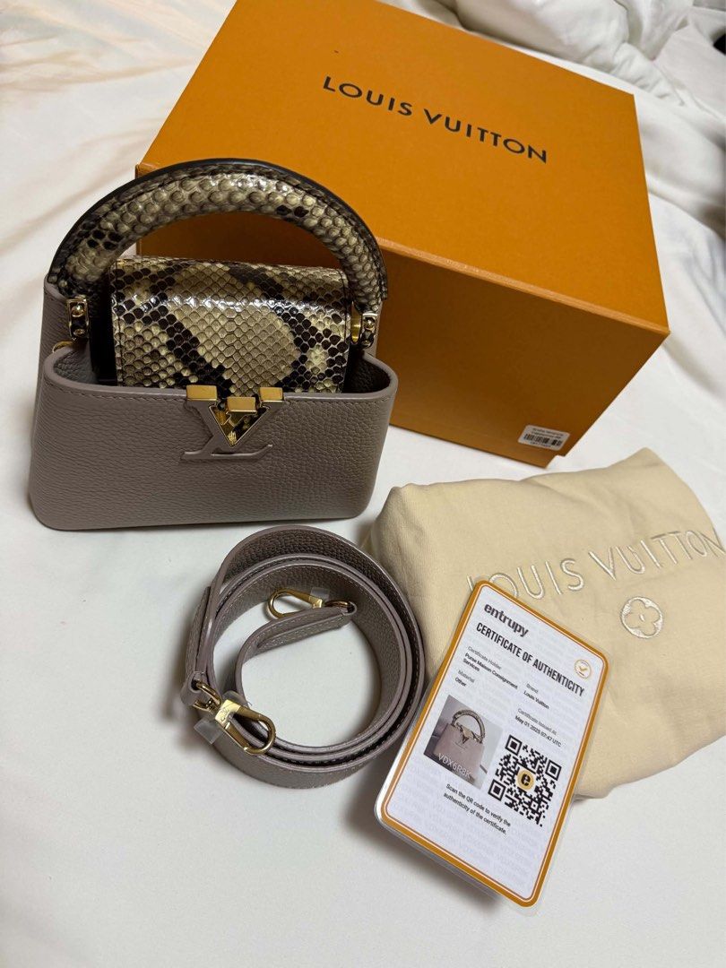 Louis Vuitton Capucines Mini Python Handle Bag (Category: Luxury Bags & Wallets) located in Cainta. Submitted by jtc23 (Listing ID 1466147387, Image 1). Description: - Model: Louis Vuitton Capucines Mini - Material: Greyish taupe taurillon leather with exotic python skin handle and flap closure - Hardware: Elegant gold-tone - Strap: Removable matching shoulder strap for versatile styling - Condition: Pristine condition, carefully stored (shape ma