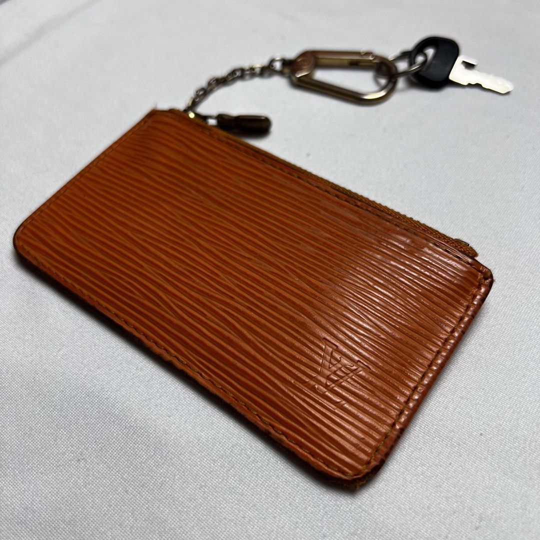 Louis Vuitton Epi Leather Key Pouch Orange (Category: Luxury Bags & Wallets) located in San Fernando. Submitted by jebeanjebb (Listing ID 1465983960, Image 3). Description: Authentic Louis Vuitton key pouch in vibrant orange Epi leather with gold-tone hardware. Compact everyday accessory featuring a zip closure, key ring, and attached chain strap with a clasp. Perfect for holding cards, cash, and keys. Clean and stylish! Orig 💯 Good condition De