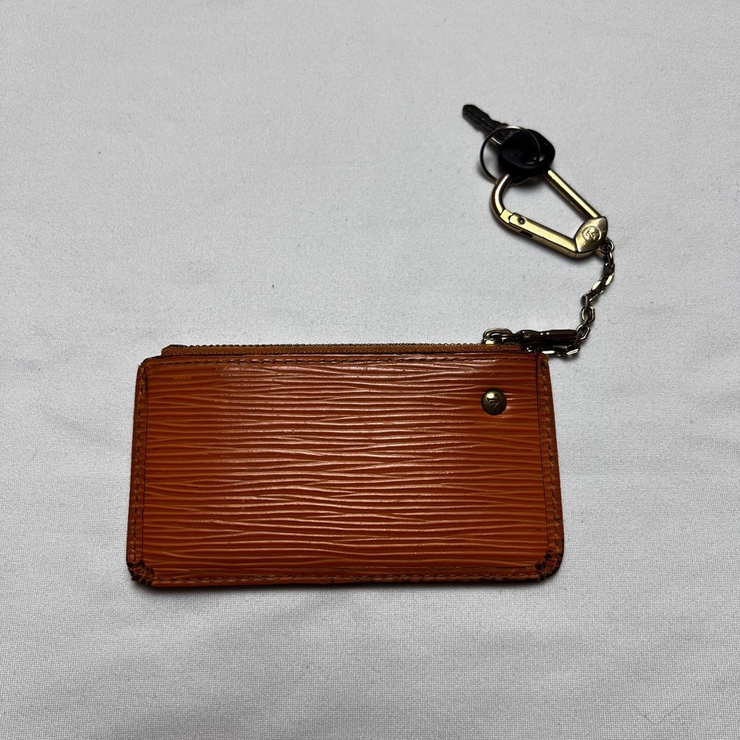 Louis Vuitton Epi Leather Key Pouch Orange (Category: Luxury Bags & Wallets) located in San Fernando. Submitted by jebeanjebb (Listing ID 1465983960, Image 2). Description: Authentic Louis Vuitton key pouch in vibrant orange Epi leather with gold-tone hardware. Compact everyday accessory featuring a zip closure, key ring, and attached chain strap with a clasp. Perfect for holding cards, cash, and keys. Clean and stylish! Orig 💯 Good condition De