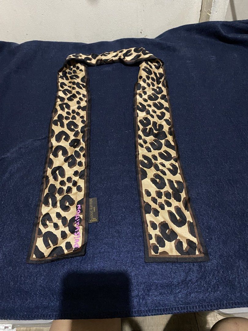 Louis Vuitton Leopard Print Silk Scarf (Category: Scarves) located in Manila. Submitted by resi.diaz (Listing ID 1466063873, Image 2). Description: - Bought at auction. - Authenticity not guaranteed. - See photos. - Sold as is. - Design: Classic leopard print in brown and tan with pink LV signature - Material: Smooth silk with hand-rolled edges - Origin: Made in Italy - Versatile Use: Ideal for neck, hair, or handbag styling - Condition: Clean an