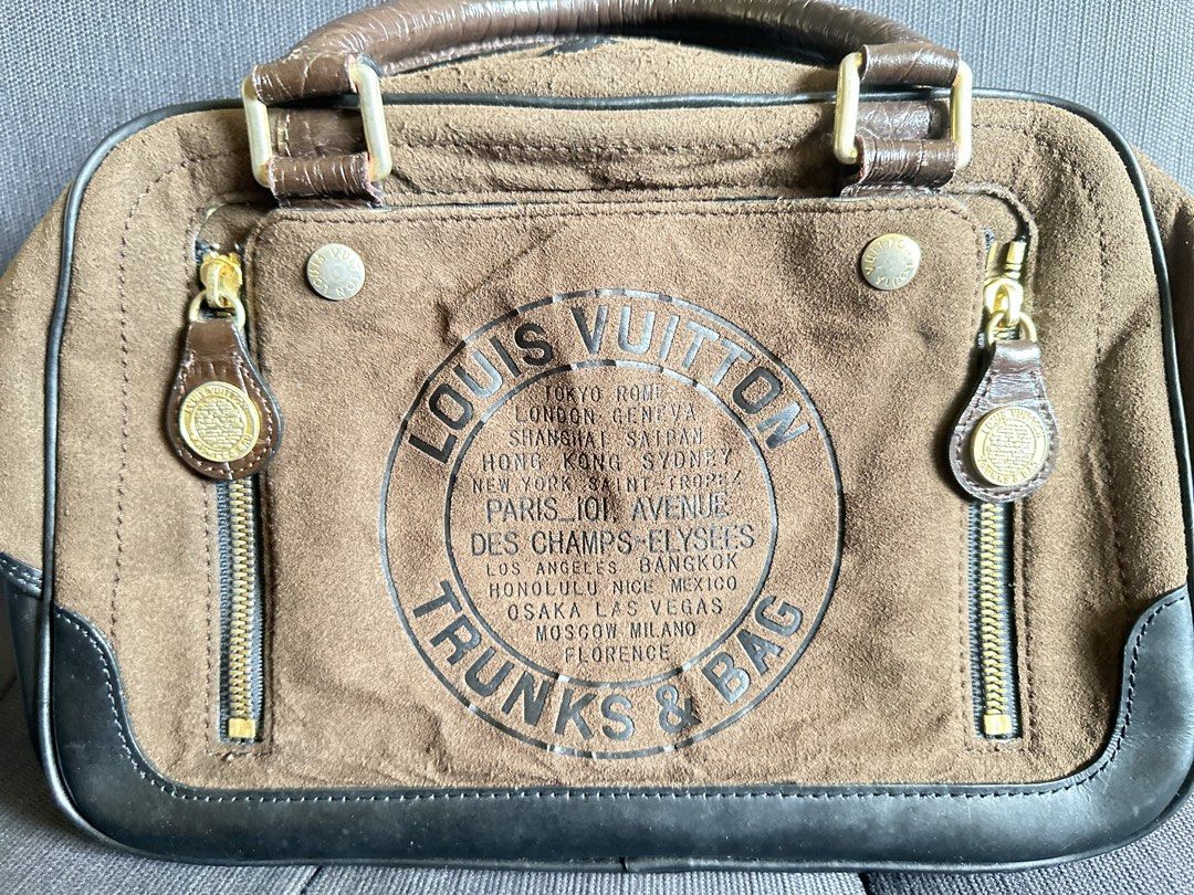 Louis Vuitton Trunks & Bags Suede Handbag (Category: Luxury Bags & Wallets) located in Quezon City. Submitted by shopaholic.kart2021 (Listing ID 1466053649, Image 2). Description: - Louis Vuitton Trunks & Bags line handbag - Luxurious brown suede body with contrasting dark leather trim - Dual top handles for easy hand or arm carry - Eye-catching large circular stamp graphic on the front - Two exterior zippered pockets with embossed pull tags - Se