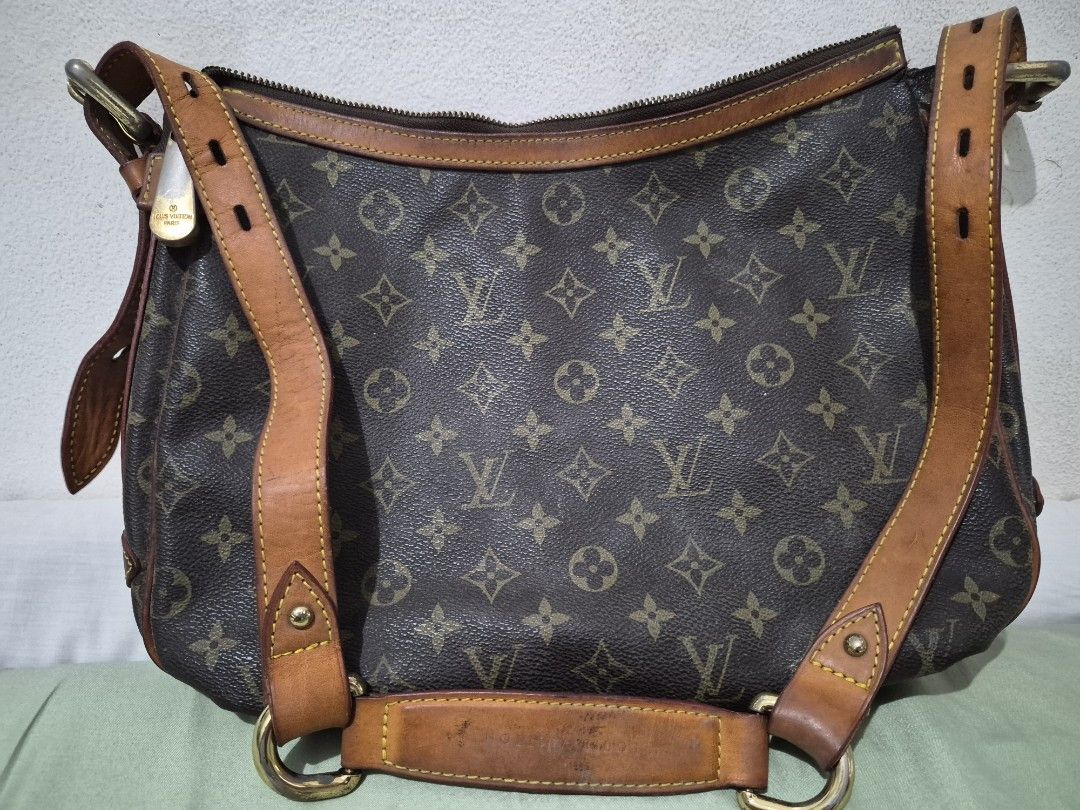 Louis Vuitton Tulum GM Monogram Shoulder Bag (Category: Luxury Bags & Wallets) located in Manila. Submitted by mrl00k (Listing ID 1466052718, Image 2). Description: Louis Vuitton Tulum GM Monogram Shoulder Bag with visible wear. Please review all photos carefully. Condition: • Torn/fraying interior lining near both ends of the top zipper. • Interior staining and discoloration. • Leather darkening, marks, and creasing. • Scratches and tarnishing o