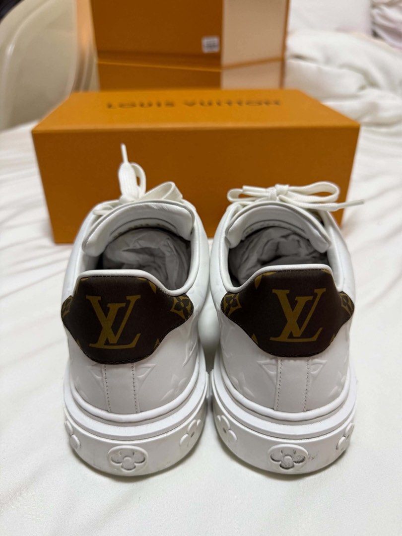 Louis Vuitton White Monogram Leather Sneakers with Box (Category: Sneakers) located in Cainta. Submitted by jtc23 (Listing ID 1466128451, Image 1). Description: - Brand: Louis Vuitton - Style: White leather sneakers with embossed Monogram pattern - Details: Brown Monogram canvas heel tab with LV logo, thick rubber sole with molded flower motifs, and gold foil LV Paris branding on insole - Condition: Clean, well-maintained - Inclusion: Original or