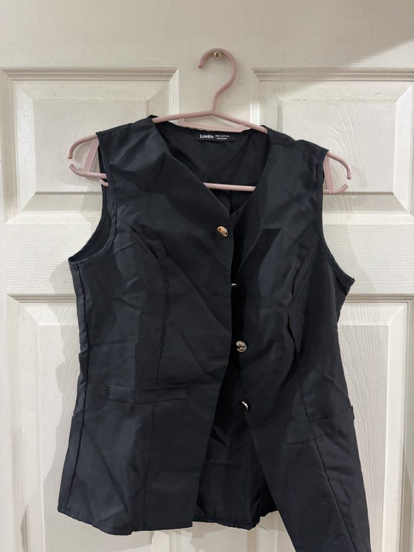Lovito Black Vest Size M EU36 US6 (Category: Vests) located in Quezon City. Submitted by elleinxx (Listing ID 1466102077, Image 1). Description: - Brand: Lovito - Size: M (EU 36, US 6) - Color: Black - Details: Button-up front with gold-toned buttons, two front pockets - Fit: Structured cut, clean fabric - Style: Great layering piece for smart casual outfits.
