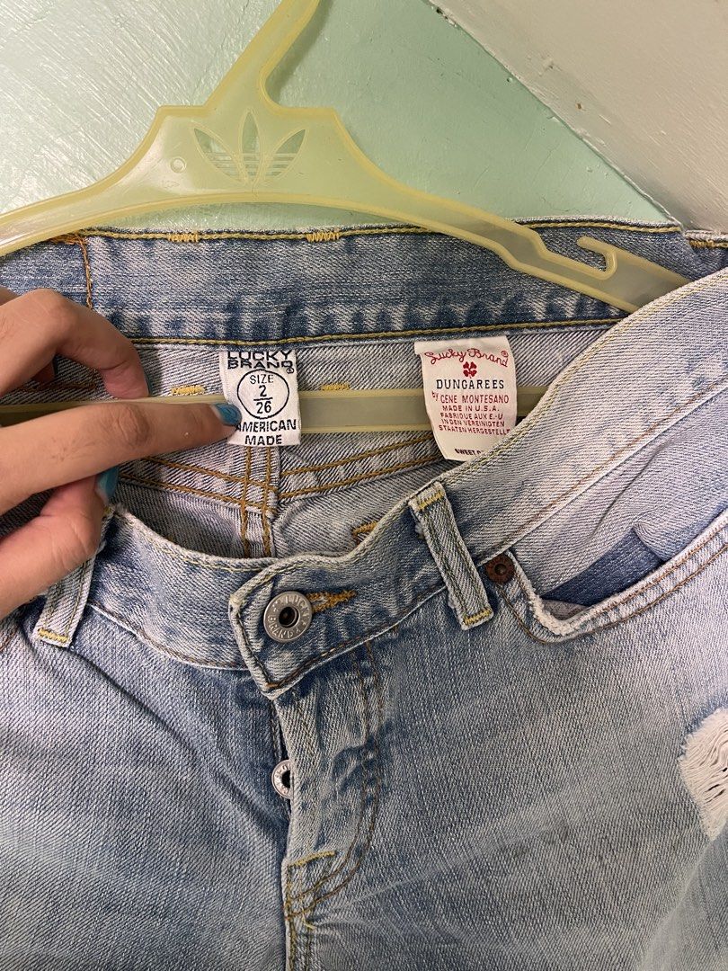Lucky Brand Dungarees (Category: Jeans) located in Baybay. Submitted by shikita27906 (Listing ID 1466028239, Image 2). Description: - Brand: Lucky Brand Dungarees - Size: 2 (26) - Wash: Light wash denim - Origin: Made in USA - Closure: Button fly - Details: Distressed knees with patch underlay, raw frayed hemline, classic clover back pocket stitch, and brown leather logo patch.