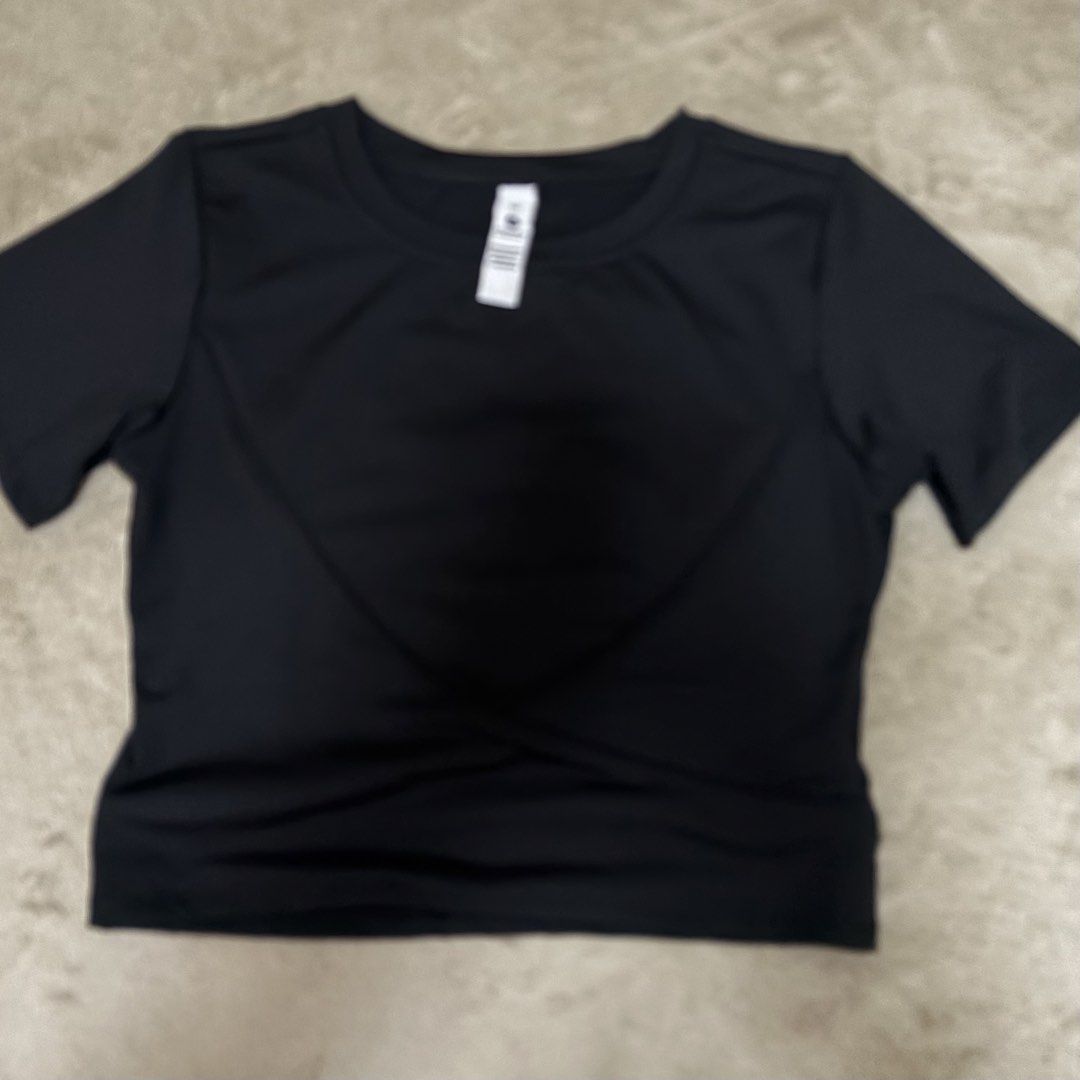 Lululemon Black Short Sleeve Crop Top (Category: Shirts) located in Quezon City. Submitted by annecsj (Listing ID 1466001505, Image 1). Description: - Brand: Lululemon - Color: Classic Black - Style: Short sleeve crop top with a flattering rounded neckline - Material: Ultra-soft, breathable athletic fabric - Details: Signature reflective Lululemon logo on the upper back - Versatility: Pairs effortlessly with high-waisted leggings or shorts for gy