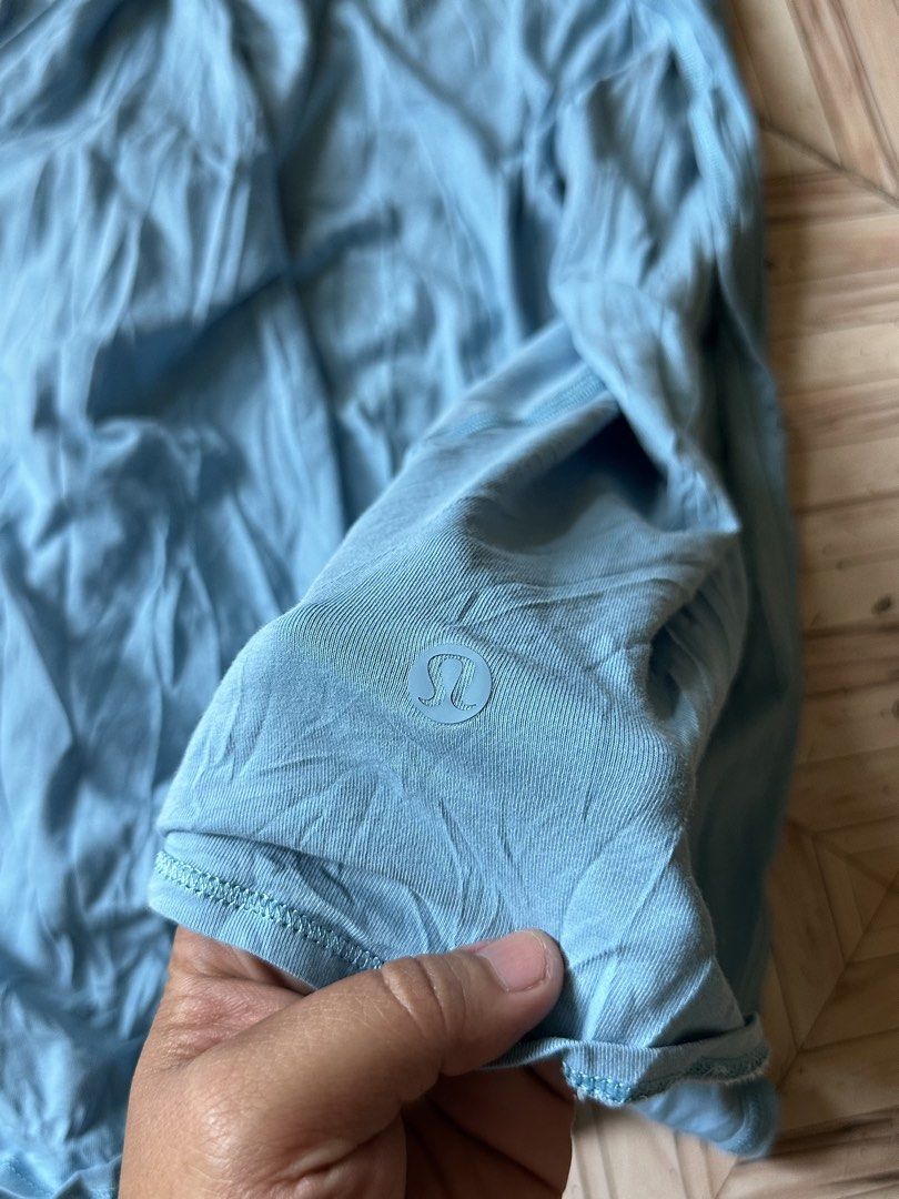 Lululemon Blue Athletic Tank Top (Category: Activewear) located in Angeles City. Submitted by alejeong27 (Listing ID 1466022911, Image 3). Description: - Brand: Lululemon - Color: Light blue - Fit: Relaxed and flowy for easy movement - Design: Racerback with a split back hem - Fabric: Breathable athletic material - Detail: Signature omega logo near the lower hem - Condition: Perfect for workouts or casual wear.