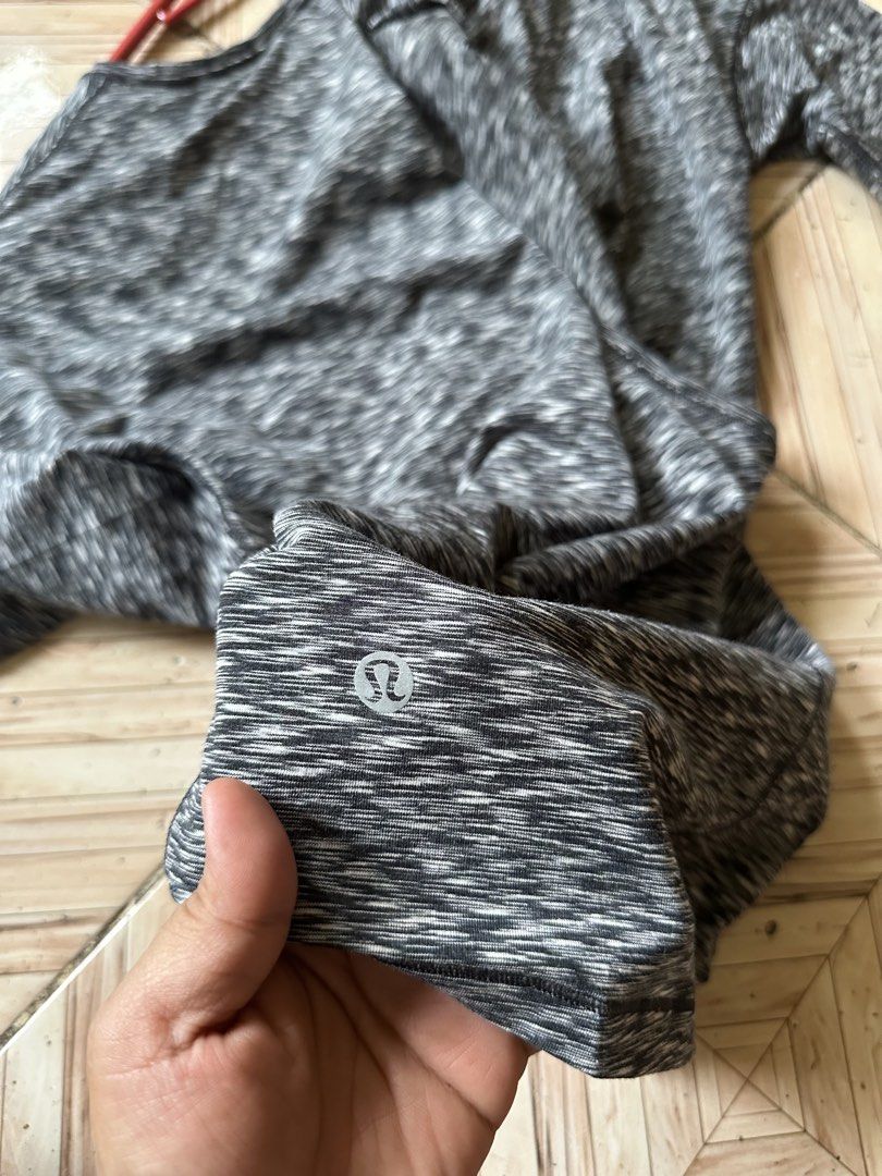 Lululemon Long Sleeve Athletic Top Space Dye Grey (Category: Longsleeves) located in Angeles City. Submitted by alejeong27 (Listing ID 1466024137, Image 3). Description: - Brand: Lululemon - Color: Grey space dye - Style: Long sleeve top with open overlapping back - Details: Reflective logo near bottom hem - Fit: Relaxed fit through the body - Material: Soft and stretchy athletic fabric - Condition: Great for workouts or casual wear.