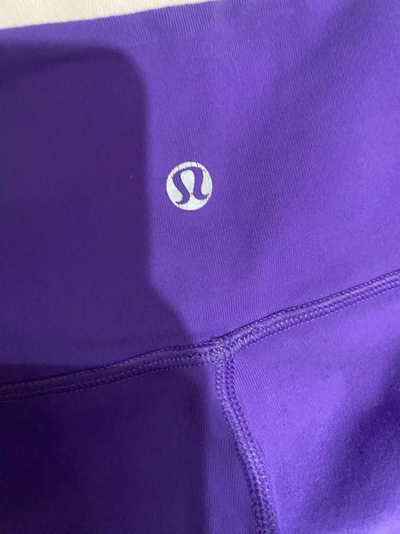 Lululemon Purple Athletic Crop Leggings (Category: Activewear) located in Manila. Submitted by lovelypreloved1497 (Listing ID 1466107640, Image 2). Description: - Brand: Lululemon - Color: Bright purple - Style: Cropped athletic leggings with high-rise waistband - Details: Iconic silver omega logo on back hip - Fit & Fabric: Super stretchy, comfortable fit with strong seams - Condition: Clean, minimal wear on the print - Ideal for: Workouts, yoga