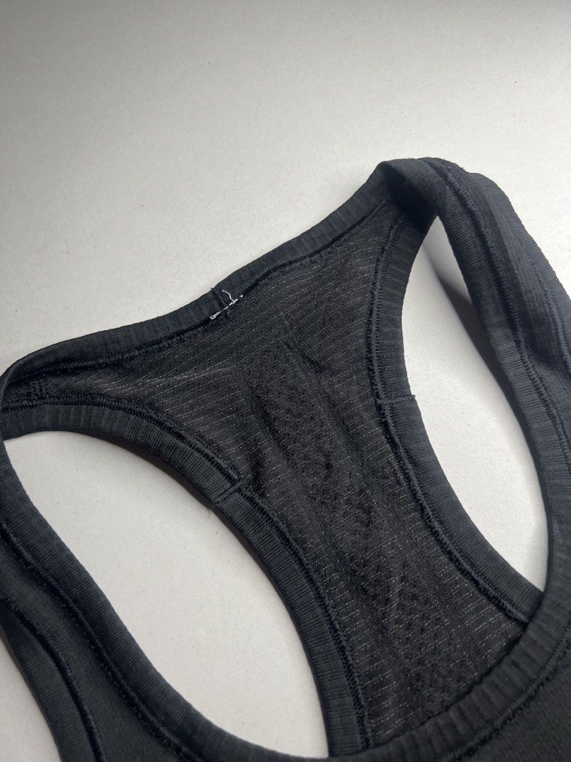Lululemon Racerback Athletic Tank Top Black (Category: Activewear) located in Tacloban City. Submitted by thrftg (Listing ID 1466114468, Image 3). Description: - Brand: Lululemon - Style: Seamless racerback tank top in solid black - Comfort: Soft, stretchy fabric with breathable ribbed knit panels - Details: Classic scoop neckline and reflective logo at the upper back - Special Feature: Interior hem with embossed branding text - Condition: Excell