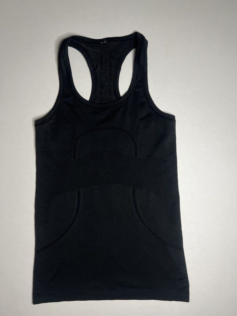 Lululemon Racerback Athletic Tank Top Black (Category: Activewear) located in Tacloban City. Submitted by thrftg (Listing ID 1466114468, Image 2). Description: - Brand: Lululemon - Style: Seamless racerback tank top in solid black - Comfort: Soft, stretchy fabric with breathable ribbed knit panels - Details: Classic scoop neckline and reflective logo at the upper back - Special Feature: Interior hem with embossed branding text - Condition: Excell