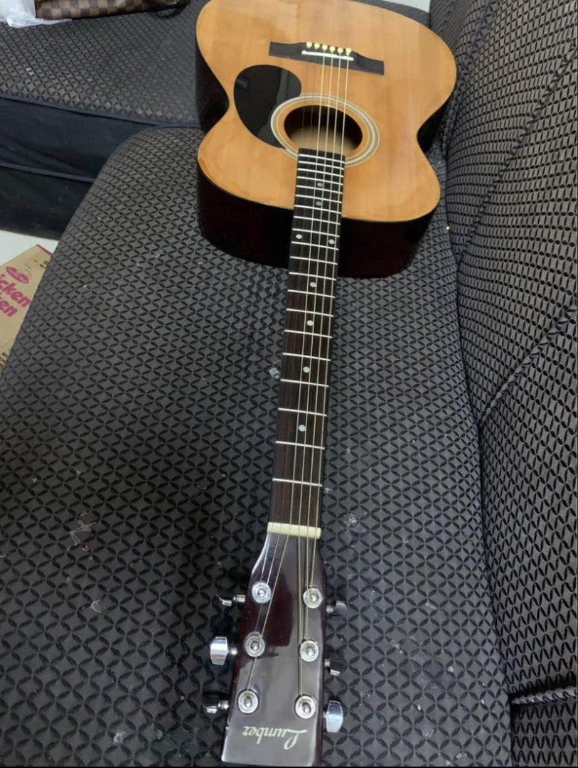 Lumber Acoustic Guitar (Category: Musical Instruments) located in Manila. Submitted by mysticfox-97fd2d (Listing ID 1466045608, Image 3). Description: - Brand: Lumber Acoustic Guitar - Condition: Good starter instrument, clean fretboard with dot markers - Features: Natural wood finish, steel strings, standard bridge, black pickguard, and six tuning pegs - Ideal for: Practice or casual playing - Delivery: Pick up only price is fix.
