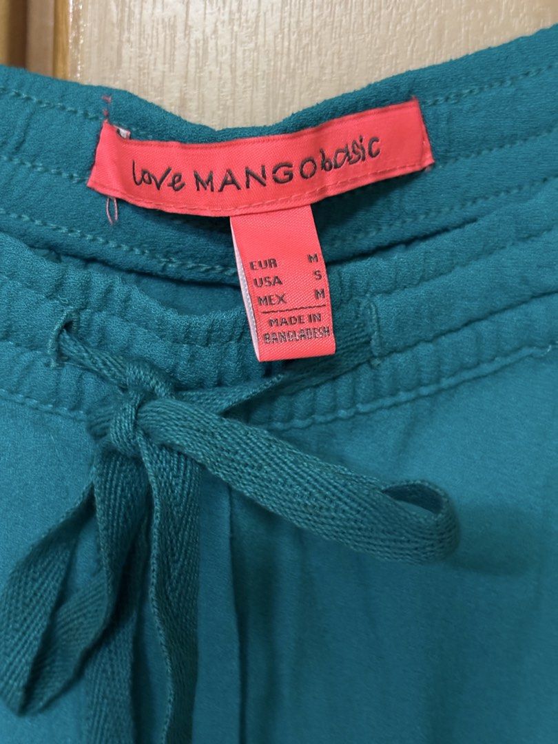 MANGO Basic Teal Drawstring Pants Size M (Category: Other Bottoms) located in Petaling Jaya. Submitted by anonymous_j (Listing ID 1465995091, Image 2). Description: - Brand: Mango Basic - Color: Teal - Size: M - Waistband: Elastic with adjustable drawstring - Pockets: Handy side pockets with metal logo charm - Fit: Relaxed fit for all-day comfort - Condition: Great for everyday casual wear.