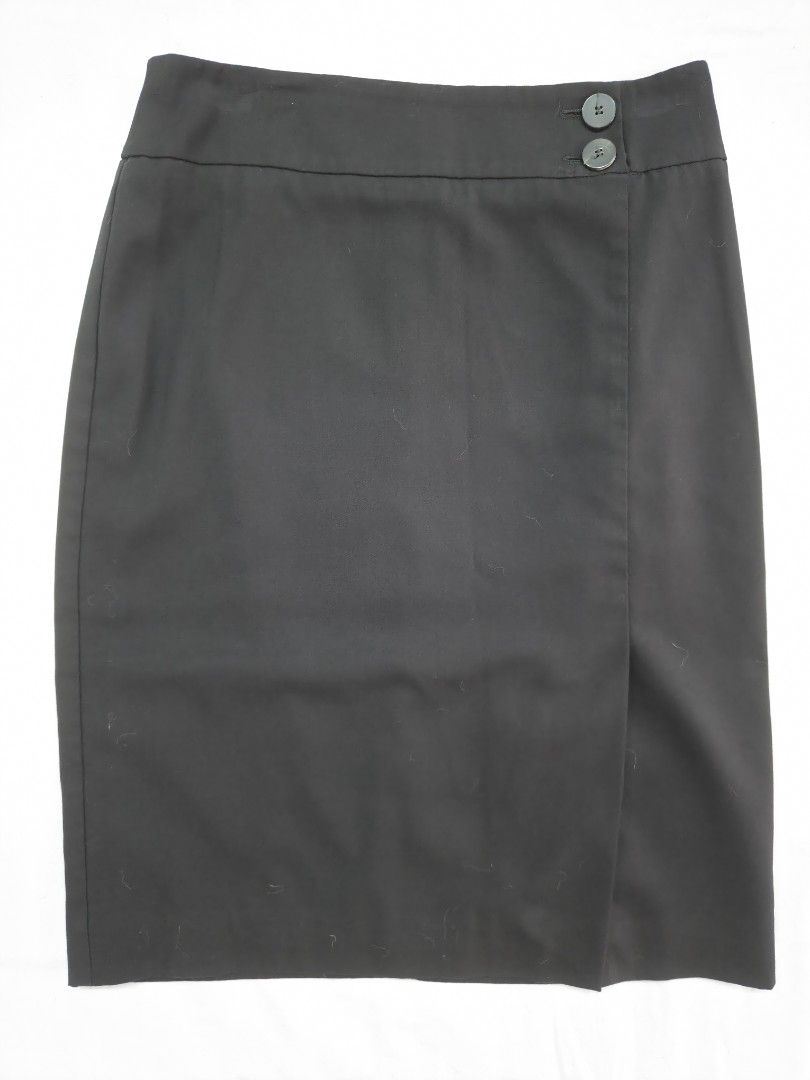 Mango Basics Black Mini Skirt Size EUR 36 (Category: Skirts) located in Quezon City. Submitted by corrnic (Listing ID 1466061086, Image 2). Description: - Brand: Mango Basics - Size: EUR 36 / USA 4 / MEX 3 - Color: Classic Black - Design: Wrap-style front with two dark buttons on the waistband - Closure: Secure zip closure at the back - Fit: Straight cut silhouette - Perfect for: Office wear, formal events, or casual weekend outings.