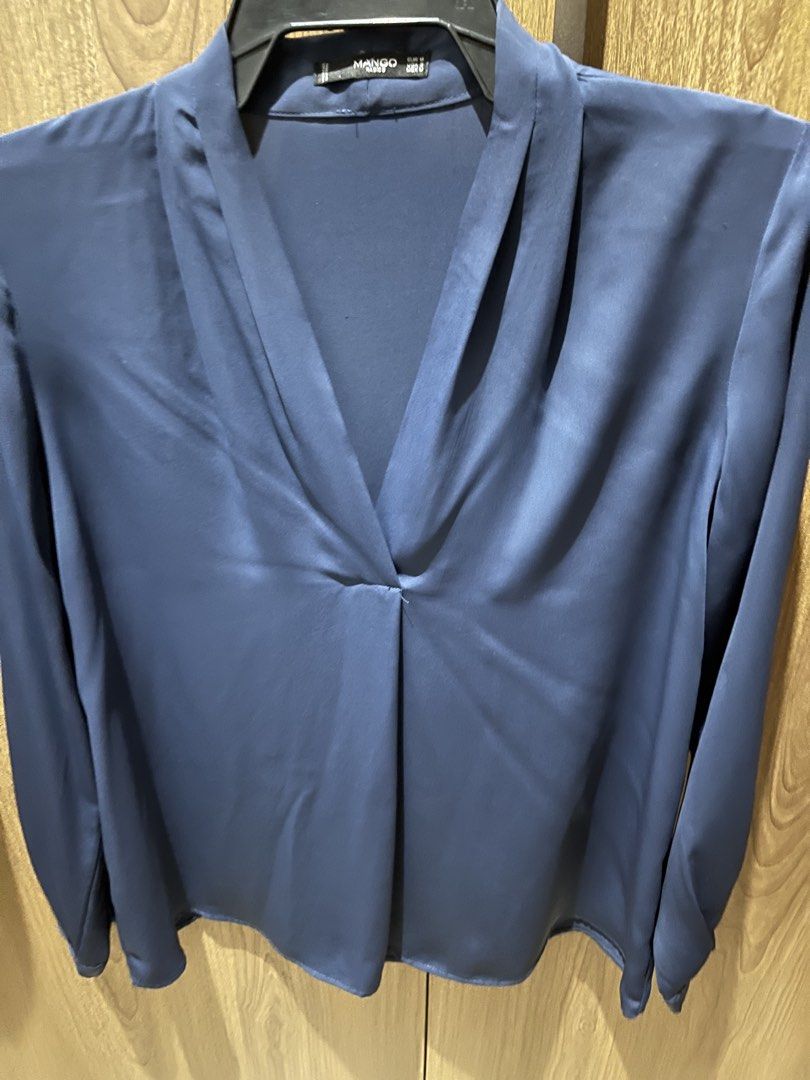 Mango Basics Blue Long Sleeve Blouse Size EUR M (Category: Longsleeves) located in Quezon City. Submitted by epictiger.c6451a (Listing ID 1465963559, Image 1). Description: - Brand: Mango Basics - Color: Blue - Size: EUR M / USA S / MEX M - Material: Smooth fabric with a slight sheen - Design: V-neck with elegant draped front and button cuffs - Origin: Made in Vietnam.