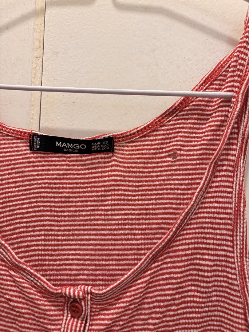 Mango Basics Red Striped Tank Top Size XS (Category: Sleeveless) located in Pasay City. Submitted by notellyyyy (Listing ID 1465992886, Image 2). Description: - Brand: Mango Basics - Design: Red and white stripes with scoop neckline and 3-button front - Size: EUR XS / USA XXS - Material: Lightweight ribbed cotton (Made in Bangladesh) - Condition: Pre-loved with a small hole on the right chest area near the strap - Perfect casual staple for warm w
