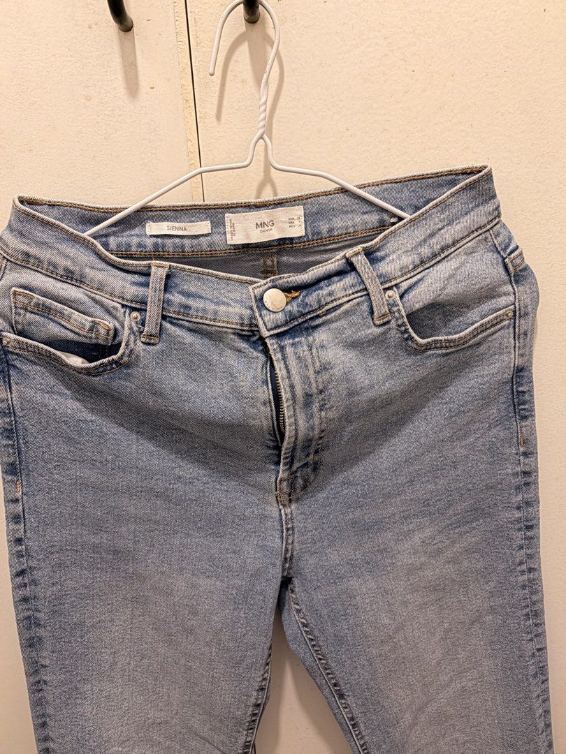 Mango Sienna Light Blue Denim Jeans (Category: Jeans) located in Pasay City. Submitted by notellyyyy (Listing ID 1465991271, Image 3). Description: SEE LAST IMAGE FOR FLAW. KINDA FLARE AT THE BOTTOM:) STILL WEARABLE!- Brand/Model: Mango Sienna Denim Jeans - Color/Wash: Light Blue / Light Wash - Details: Raw hem edges, classic button and zip fly, front and back pockets - Condition: Great overall, with a tear near the back belt loop (shown in close